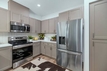 a kitchen with stainless steel appliances and white cabinetsat Weylyn Luxury Apartments, Laveen, AZ